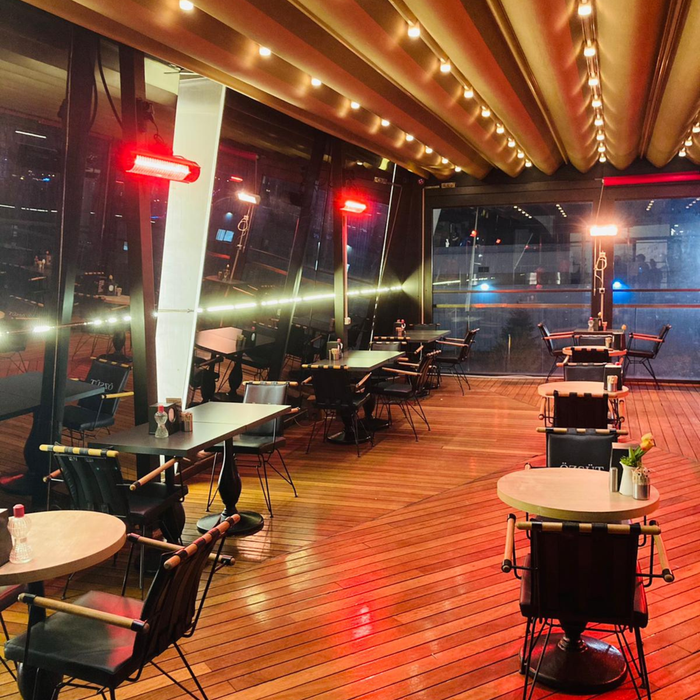 RADtec infrared patio heaters installed in a restaurant with wooden floors and ambient lighting.