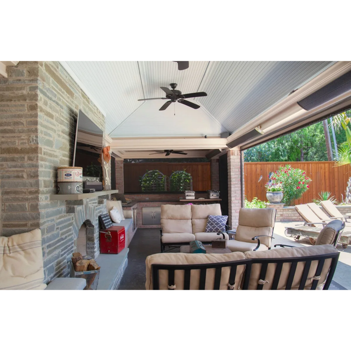 Luxury covered outdoor living space with mounted RADtec zero light patio heaters, fireplace, and lounge seating