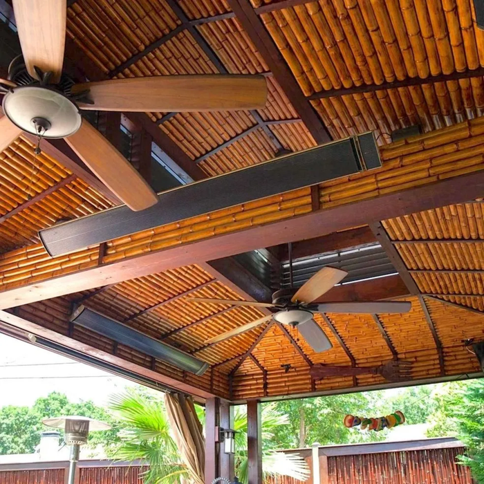 Tropical bamboo patio ceiling with mounted RADtec zero light infrared heaters and ceiling fans for outdoor comfort
