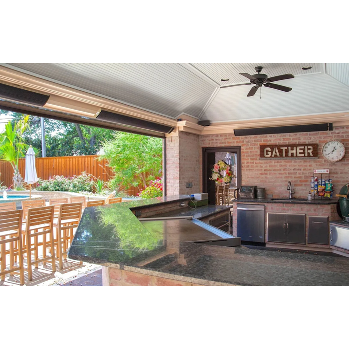 Covered outdoor kitchen and bar with mounted RADtec zero light patio heaters and ceiling fans for all-season entertaining