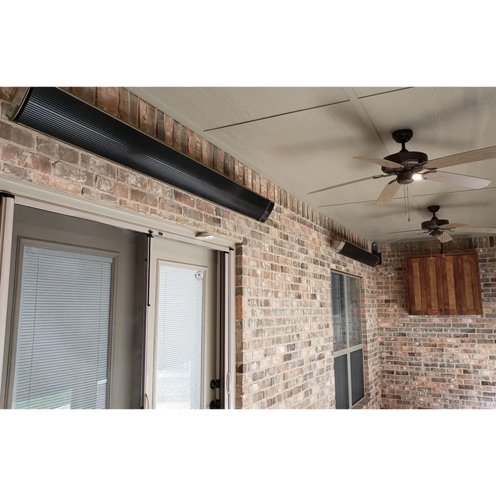 Brick-walled covered patio with mounted RADtec zero light infrared heaters and ceiling fans for year-round use