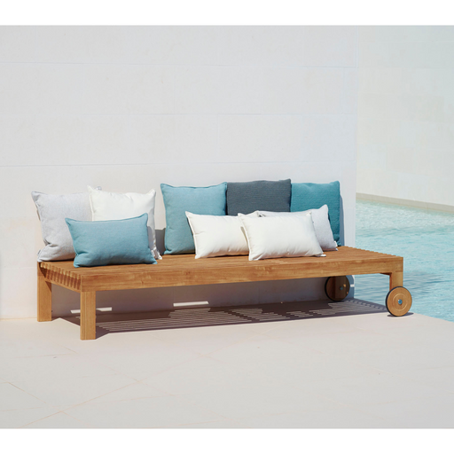 cane-line amaze sunbed teak sunbed without cushion leaning back with cushions in a pool lifestyle