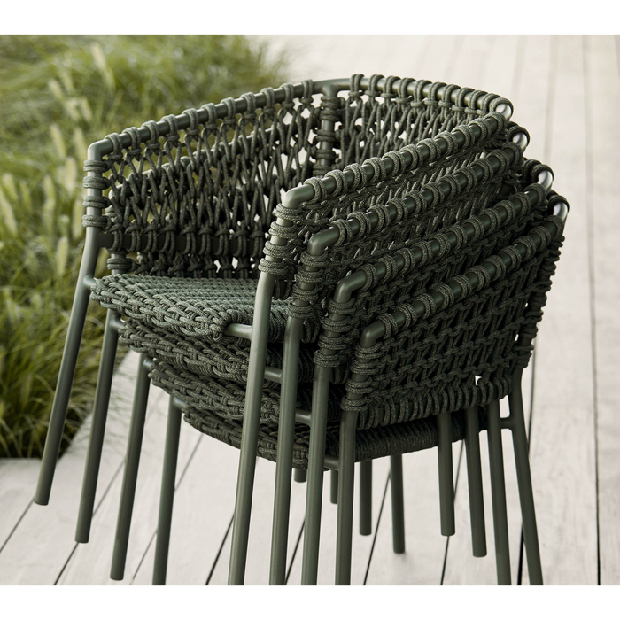 lifestyle image of cane-line ocean chair in Dark Green, Open Cane-line Soft Rope chair without cushion in a patio.