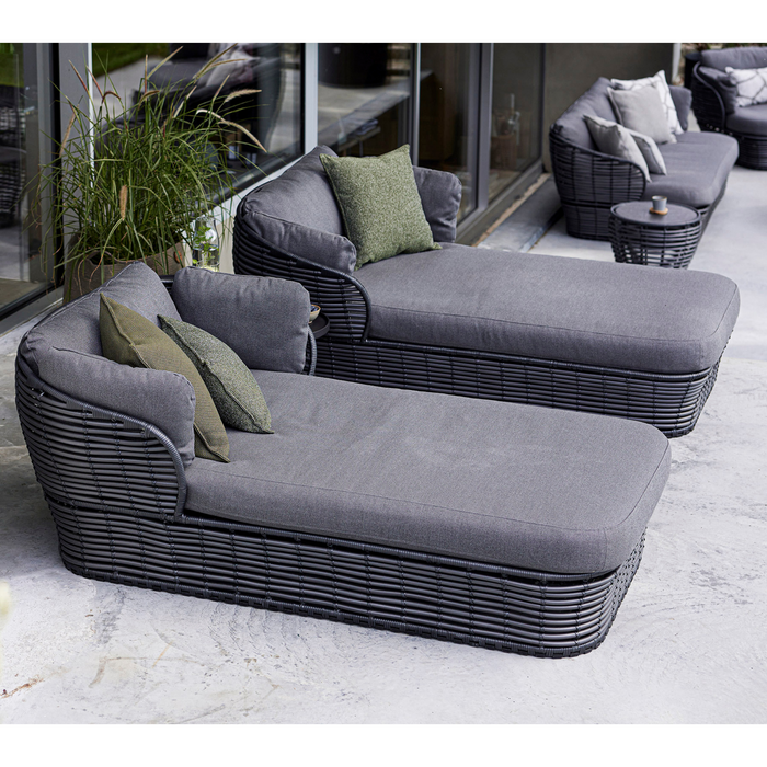 lifestyle image of cane-line basket daybed in Graphite, Braid Cane-line Weave w/Grey Cane-line AirTouch in a patio with basket furniture and outdoor cushions