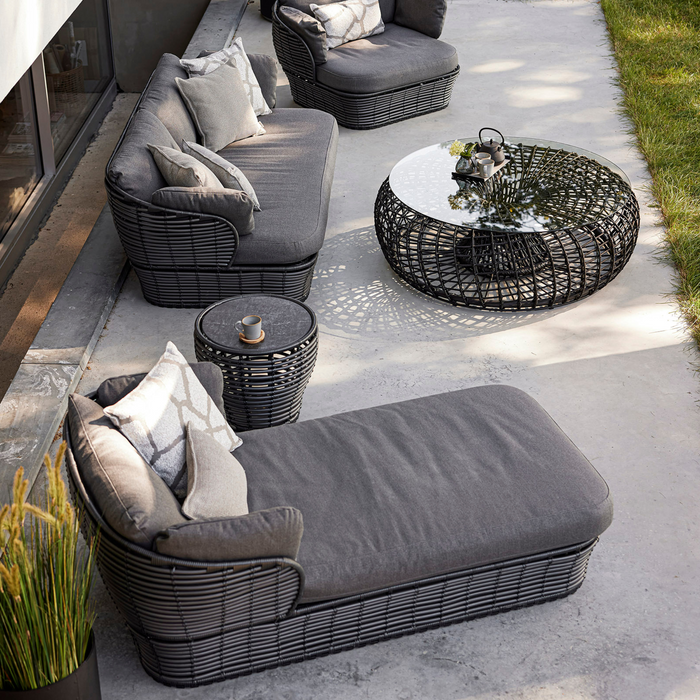 lifestyle image of cane-line basket daybed in Graphite, Braid Cane-line Weave w/Grey Cane-line AirTouch in a patio with basket furniture