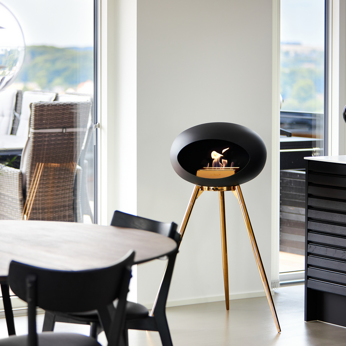 Le Feu Black Dome Bioethanol Fireplace ground high rose gold bowl, rose gold legs and rose gold burner indoor with indoor furniture lifestyle