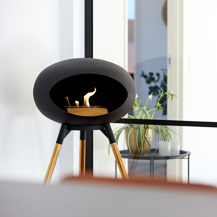 Le Feu Black Dome Bioethanol Fireplace ground high black bowl, rose gold legs and rose gold burner indoor lifestyle