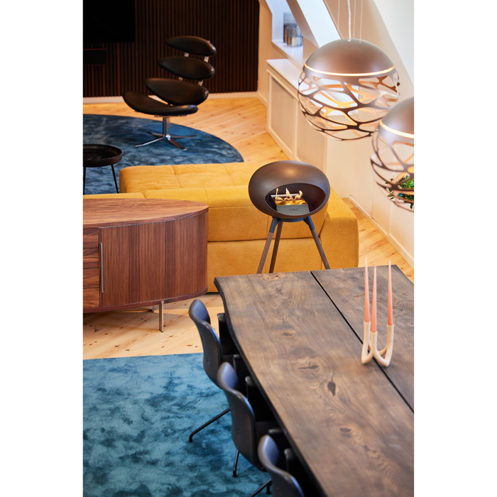 Le Feu Mocca Dome Bioethanol Fireplace ground high black bowl, smoked legs and steel burner indoor with dining table and chairs lifestyle