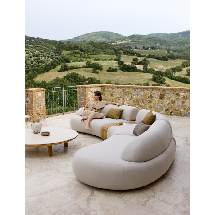 cane-line mellow 5 seater sofa Sand, Cane-line AirTouch sofa in a patio with outdoor furniture and a woman enjoying the sofa lifestyle