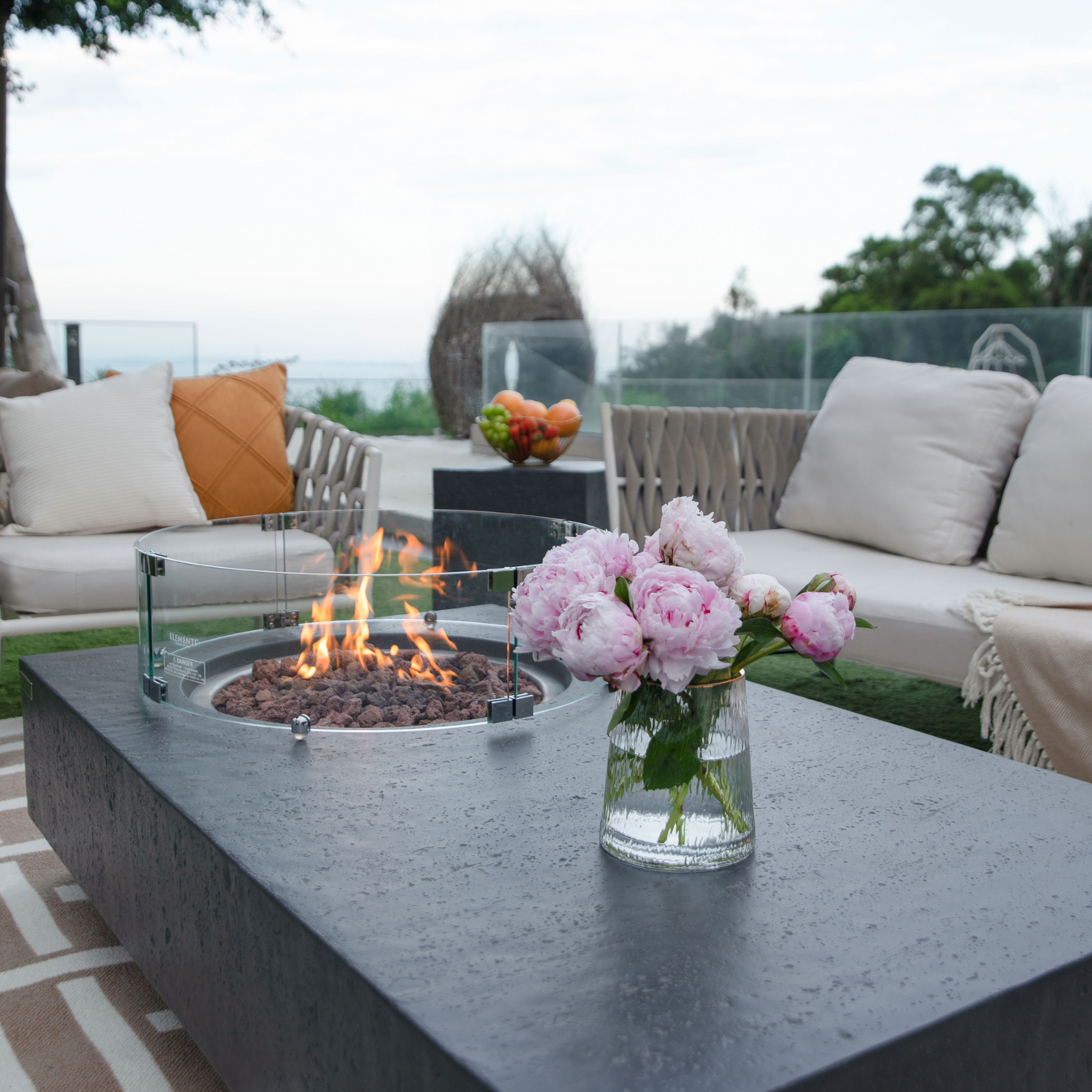 56 concrete propane natural gas fire table outdoor with wind screen and outdoor furniture lifestyle