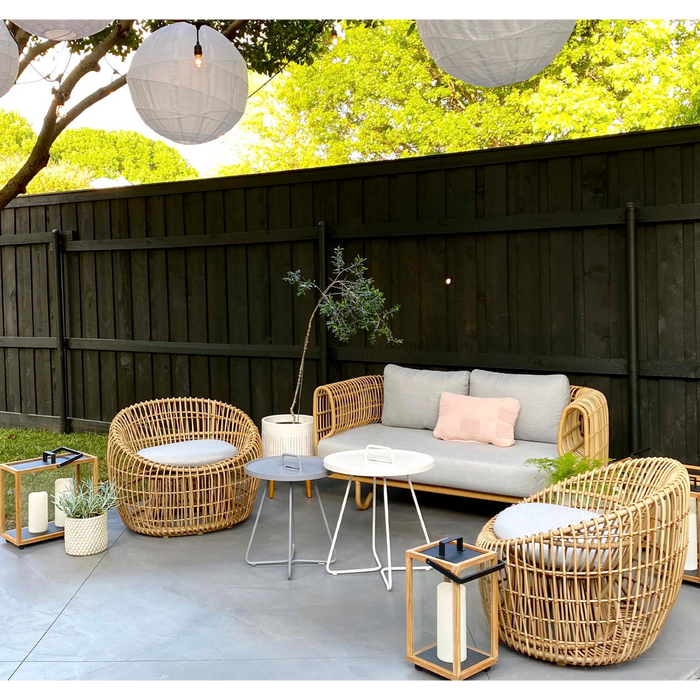 Nest outdoor 2 seater Sofa Light Grey Natte cushion in a patio with outdoor furniture lifestyle