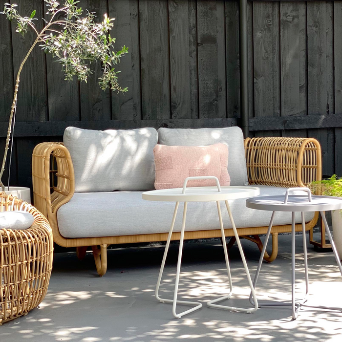Nest outdoor 2 seater Sofa natural and Natte cushion in a patio lifestyle