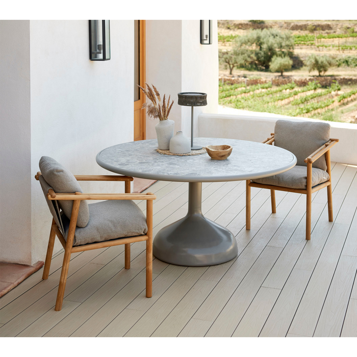 cane line Sticks armchair teak legs light brown Cane line Rise cushion lifestyle with round dining table