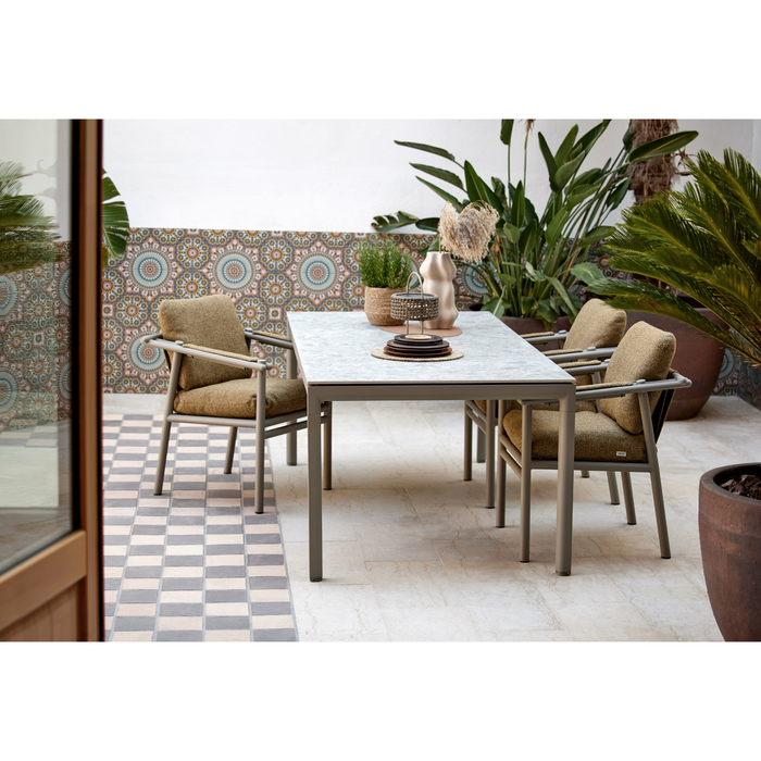 cane line Sticks armchair Taupe aluminium Turmeric yellow Cane line Rise cushion lifestyle with dining table