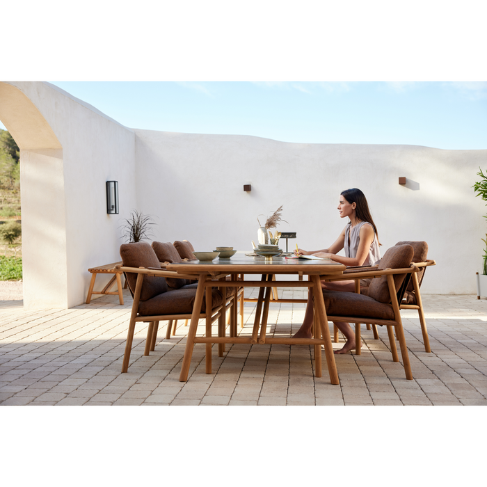 cane line Sticks armchair Teak Umber brown Cane line Rise cushion lifestyle with dining table