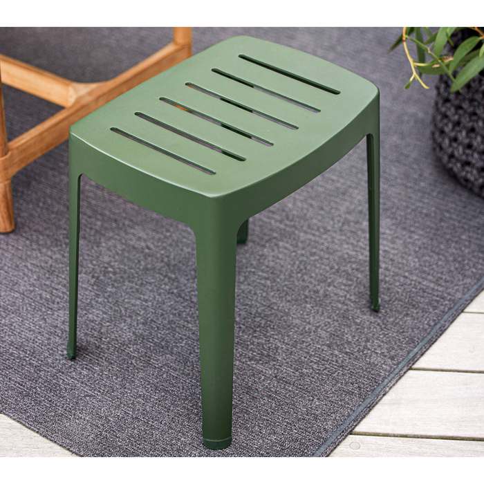 lifestyle image of cane-line cut stool in Dark Green, Aluminium chair without cushion in a patio with outdoor rug