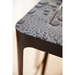 lifestyle image of cane-line cut stool in Black, Aluminium chair without cushion with water in a patio