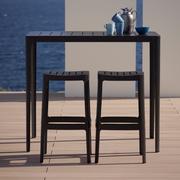 lifestyle image of cane-line cut bar chair in Black, Aluminium without cushion in a patio with cut bar table