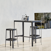 lifestyle image of cane-line cut bar chair in Black, Aluminium without cushion in a lounge with cut bar table