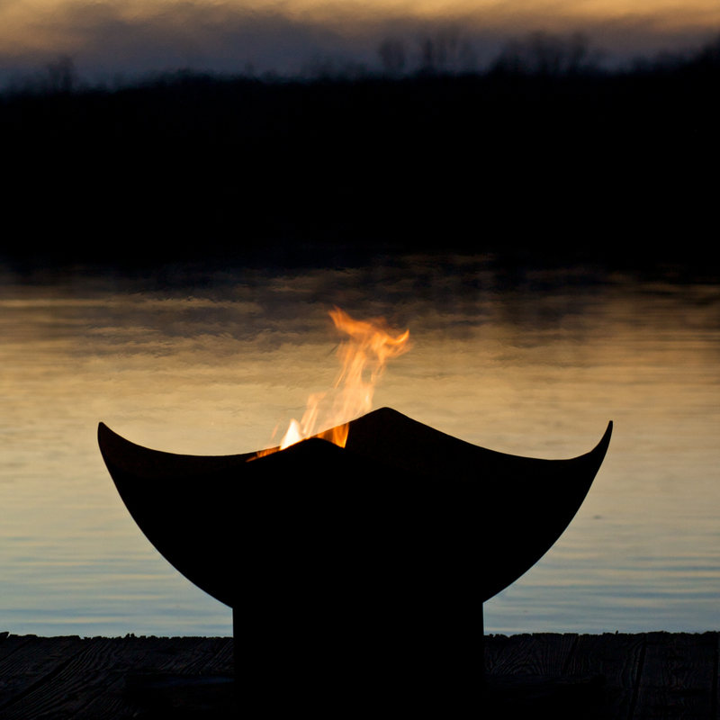 Fire pit art outdoor Manta Ray fire pit stainless steel with wood in a lake lifestyle