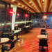RADtec infrared patio heaters installed in a restaurant with wooden floors and ambient lighting.