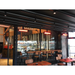 Commercial space featuring RADtec patio heaters glowing red above a bar-style seating area.