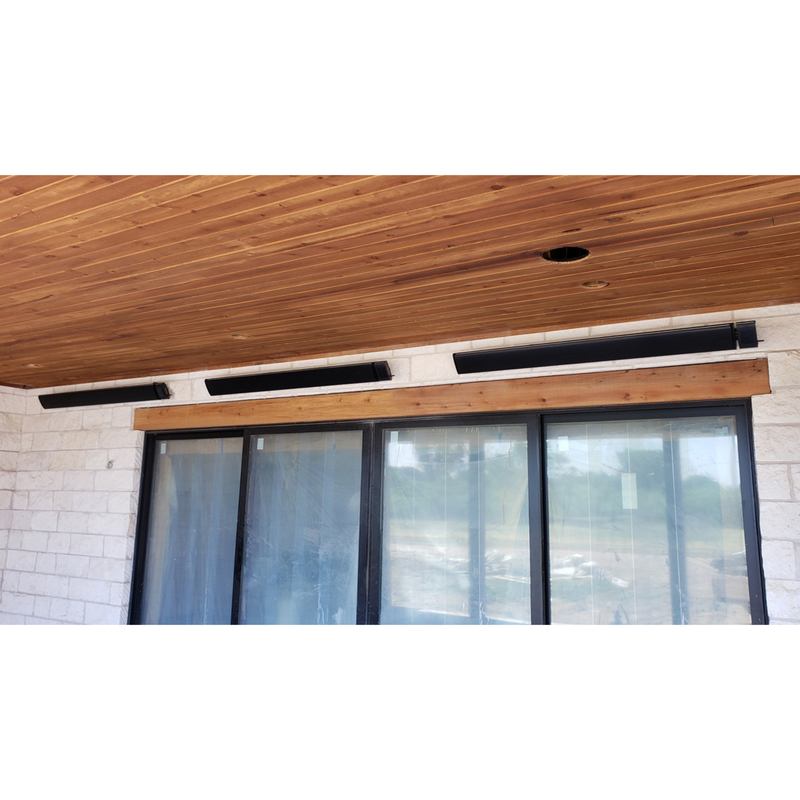 Wooden ceiling with rad tec mounted heater above a glass door.