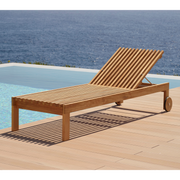 cane-line amaze sunbed teak sunbed without cushion leaning forward in a pool lifestyle