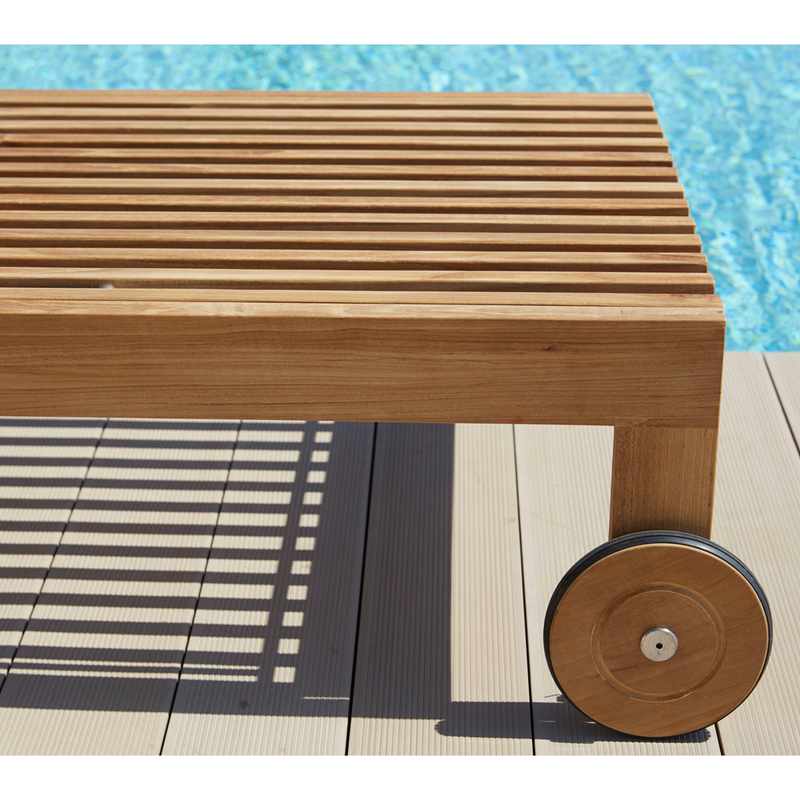 cane-line amaze sunbed teak sunbed without cushion wheels in a pool lifestyle