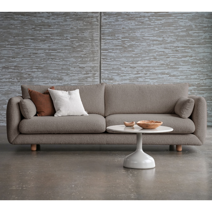 lifestyle image of cane-line glaze coffee table in large size with Sand, Semi Glossy Aluminium and Sand, Lava Stone Glazed table top in a lounge with a sofa