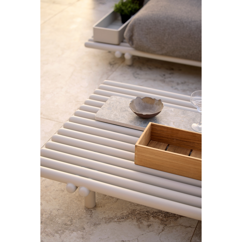 cane-line sticks platform coffee table sand,aluminium coffee table in a patio with sticks platform sofa lifestyle