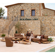 cane-line sticks platform coffee table teak coffee table in a patio with sticks platform sofa lifestyle