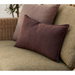 lifestyle image of cane-line free scatter cushion 19" x 19" in Bordeaux, Cane-line Free and cane-line free scatter cushion 12"" x 20" in Bordeaux, Cane-line Free on a sofa in a patio close up