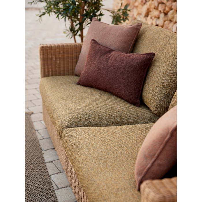 lifestyle image of cane-line free scatter cushion 19" x 19" in Bordeaux, Cane-line Free and cane-line free scatter cushion 12"" x 20" in Bordeaux, Cane-line Free on a sofa in a patio