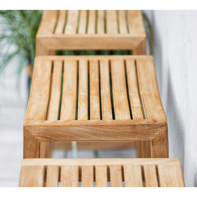 lifestyle image of cane-line flip bar chair in teak in a patio close up
