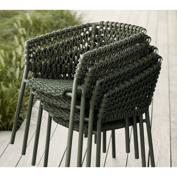 lifestyle image of cane-line ocean chair in Dark Green, Open Cane-line Soft Rope chair without cushion in a patio. 