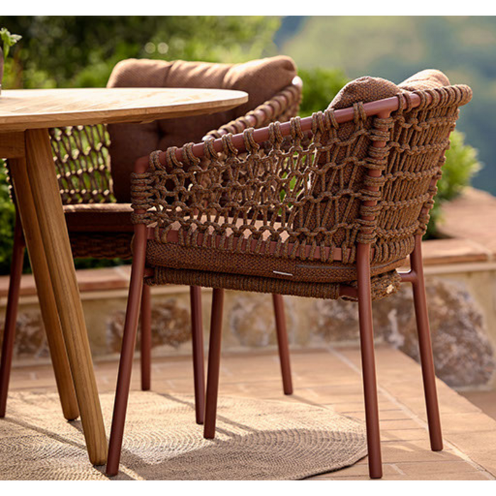 cane-line ocean chair Umber Brown, Open Cane-line Soft Rope chair with Umber Brown, Cane-line Rise cushion in a patio with dining table lifestyle