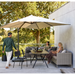 cane-line connect dining lounge corner module Taupe, Large Round Cane-line Weave with Taupe, Cane-line Natté w/Seat & Back Cushion in a patio with outdoor furniture and two women enjoying the sofa lifestyle