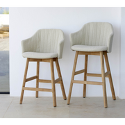 lifestyle image of cane-line choice bar chair in Black, Polypropylene, Up to 98% Recycled chair, teak base and Sand, Cane-line Free cushion in a lounge