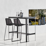 lifestyle image of cane-line breeze bar chair in Black, Small Round Cane-line Weave with bar table in a lounge