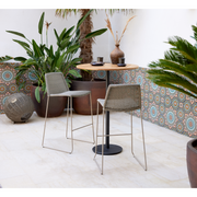 lifestyle image of cane-line breeze bar chair in Taupe, Small Round Cane-line Weave with bar table in a patio