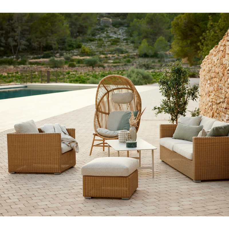 cane line hive chair Natural, small round tube Cane-line Weave with teak base and Sand, Cane-line AirTouch cushion in a patio with outdoor furniture lifestyle