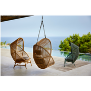 cane line hive chair all colors and base and soft rope in a patio with a pool lifestyle