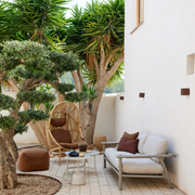 cane line hive chair Natural, small round tube Cane-line Weave with Teak base and Umber brown, Cane-line Rise cushion in a patio with outdoor furniture lifestyle