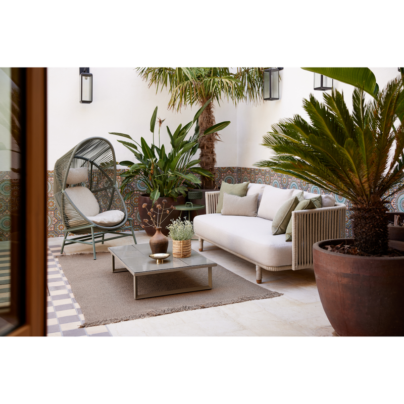 cane line hive chair Dusty green, small round tube Cane-line Weave with Dusty green, aluminium base and Sand, Cane-line AirTouch cushion in a patio with outdoor furniure lifestyle