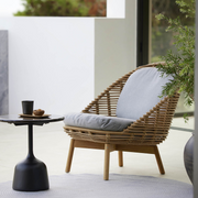 cane-line cushion set hive chair light brown cushion on a hive chair in a patio with outdoor furniture lifestyle