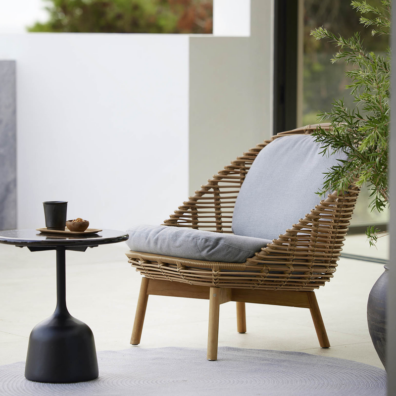 cane-line cushion set hive chair light brown cushion on a hive chair in a patio with outdoor furniture lifestyle