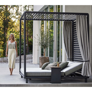 lifestyle image of cane-line laze cabana in Lava Grey, Aluminium Incl. Light Grey Cane-line Natté in a patio with outdoor cushions