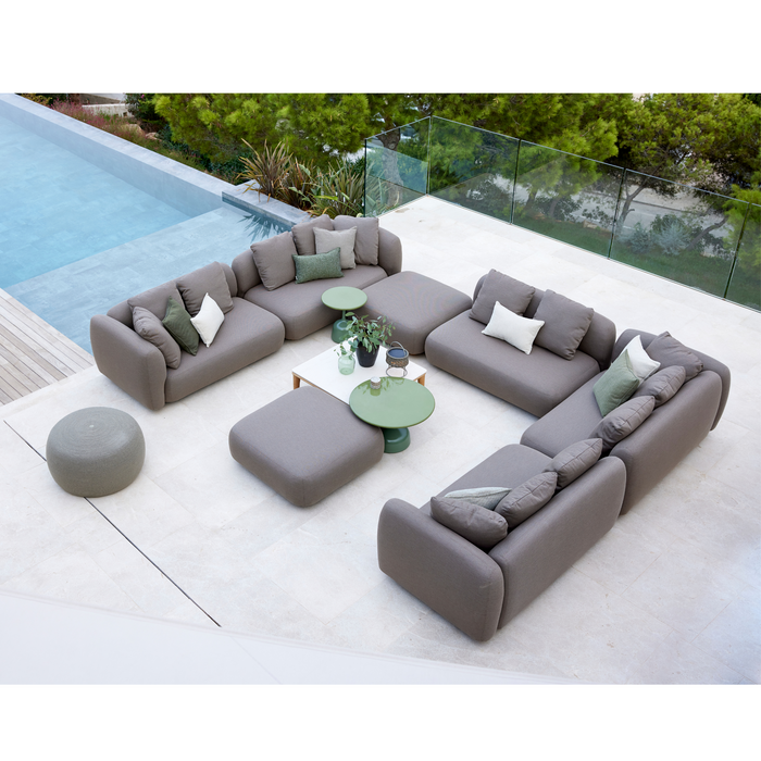 cane-line capture 2 seater sofa module taupe, cane-line airtouch sofa in a patio with pool and outdoor furniture lifestyle