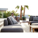 cane-line capture 2-seater sofa left module taupe, cane-line airtouch sofa in a patio with outdoor furniture and a man enjoying the sofa lifestyle